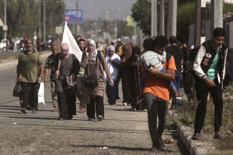 Gazans wave white flags and hold up ID papers as they flee south